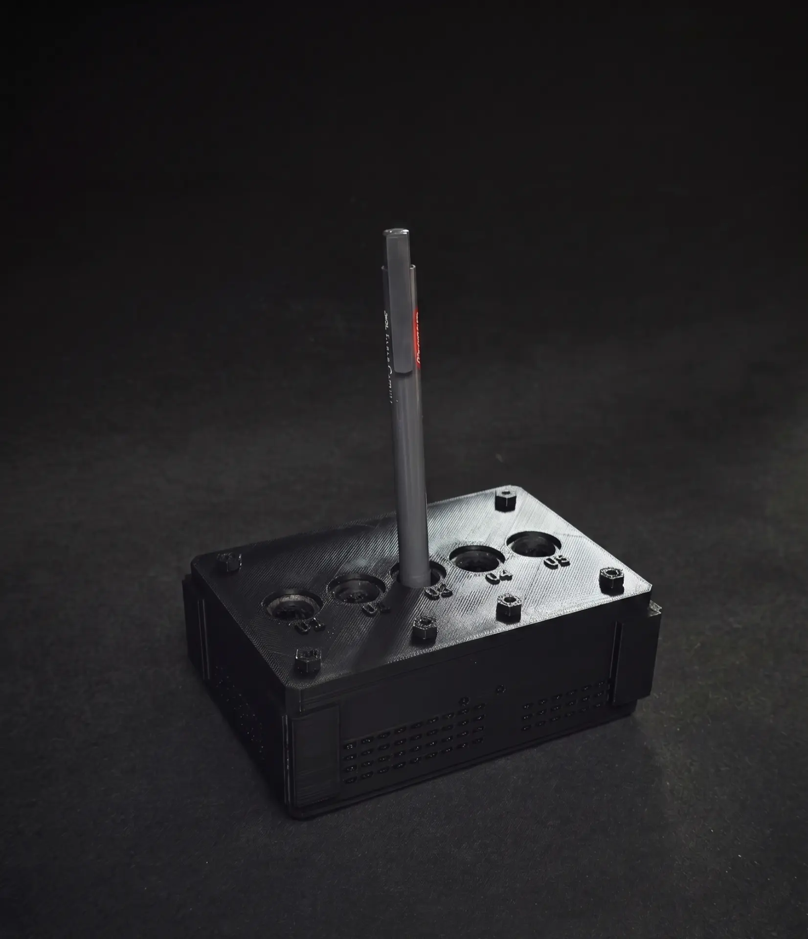 Finished 3D-printed mini server rack pen holder with a pen inserted